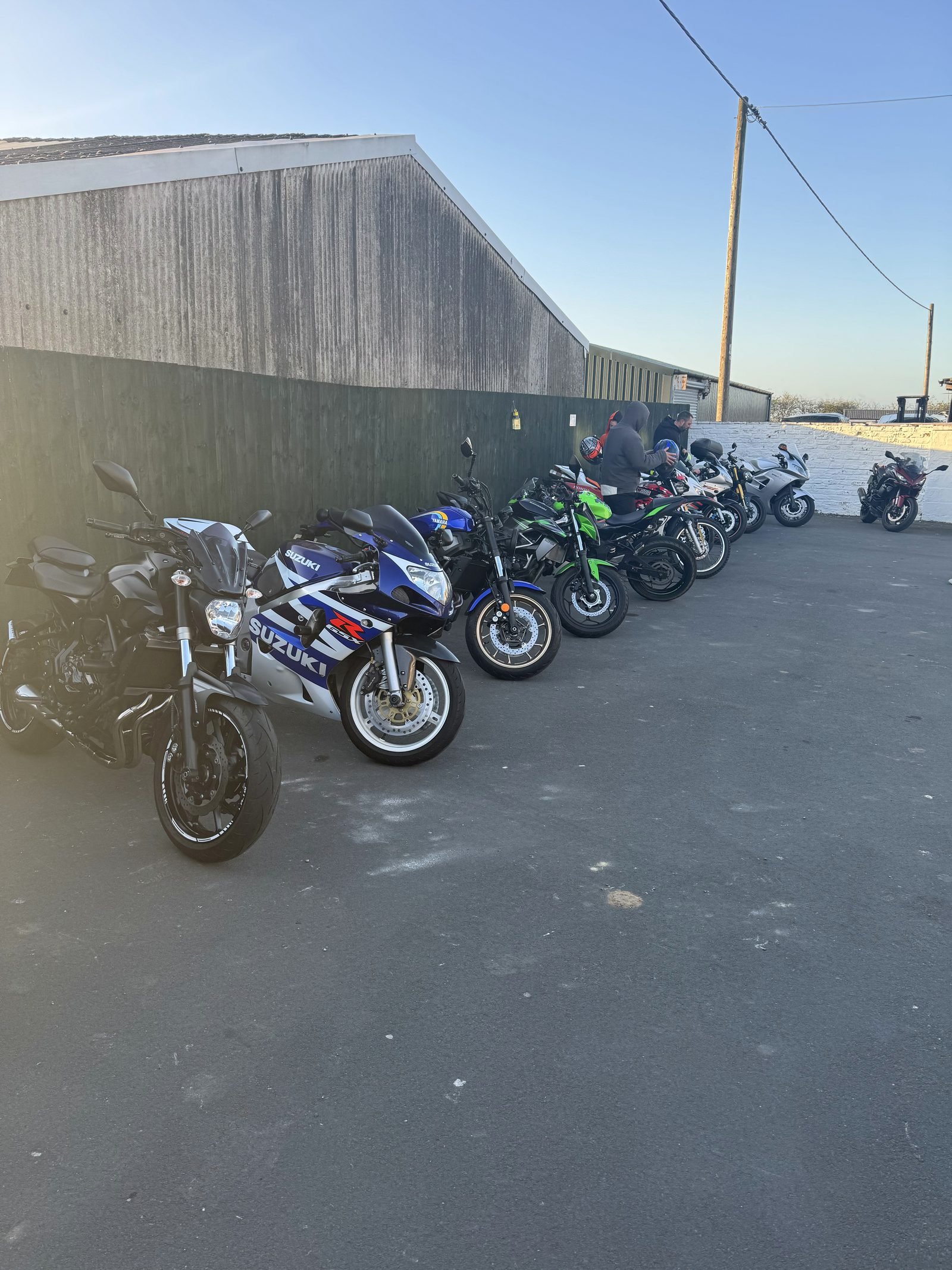Line of motorbikes along the café wall